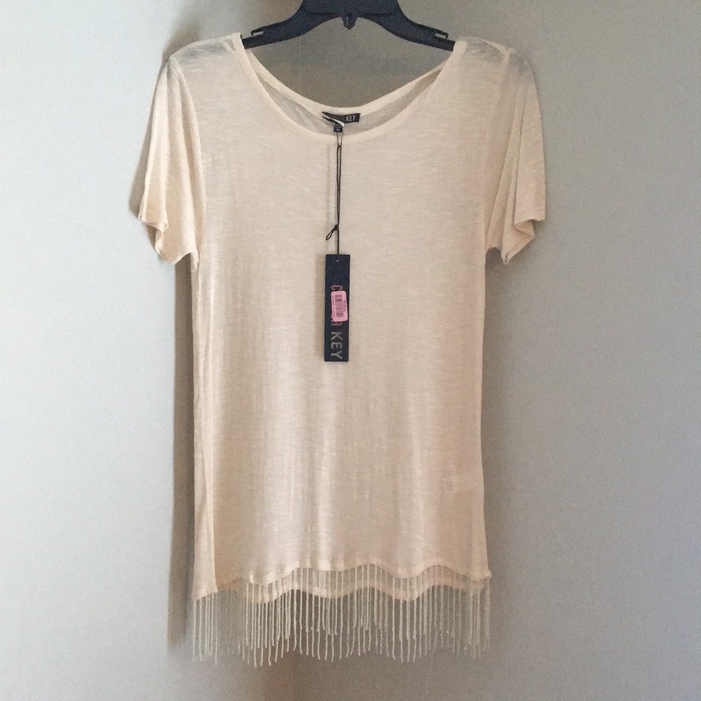 Cream colored t shirt with beaded tassels